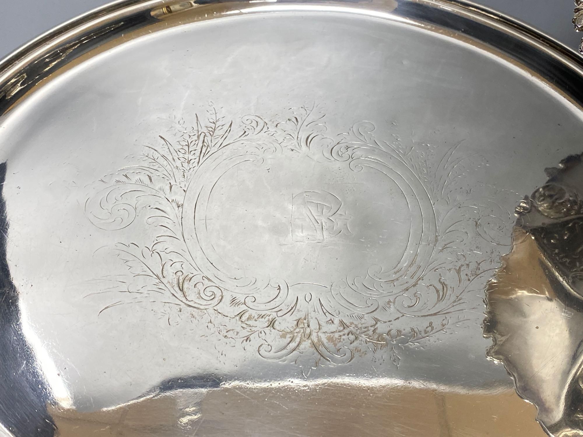 A silver plated cake basket, with cast border, diameter 31cm, two plated trays and three other items